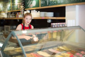 Jobs for 14 Year Olds smiling while bagging groceries at a local store