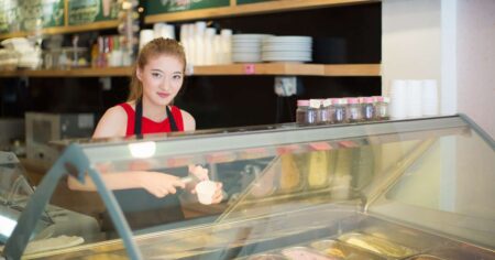 Jobs for 14 Year Olds smiling while bagging groceries at a local store